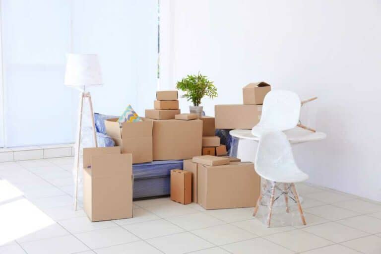 a room with many boxes and a table as illustration for the page "move management services"