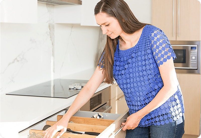 Professional organizer Olena from Harmony Home Organizing in the process of organizing a kitchen.