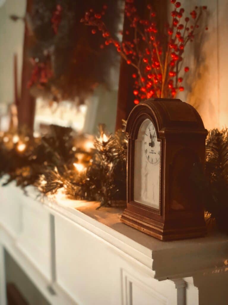 Illustration for "Prepare your Vancouver Home for the Holidays". Clock and Christmas decorations on top of a fireplace mantel.