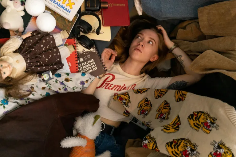 Conquer the Chaos: 7 Easy Steps to a Perfectly Organized Teen Room 1 Teenager lying on a bed surrounded by clutter of objects. Illustration for blog post: organizing your teenager's room"