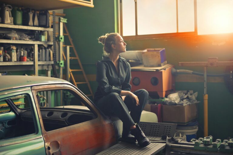 Woman sitting in a cluttered garage. Illustration for garage organizing process.