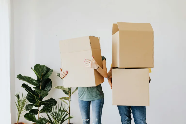 2 people carrying moving boxes, illustrations for best packing and moving company blog post
