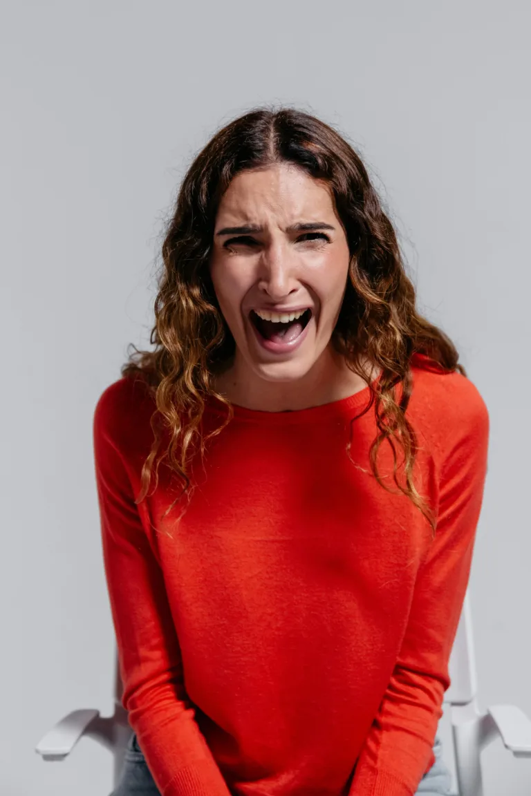 Woman in a red jumper screaming as illustration for "time to organize your home"