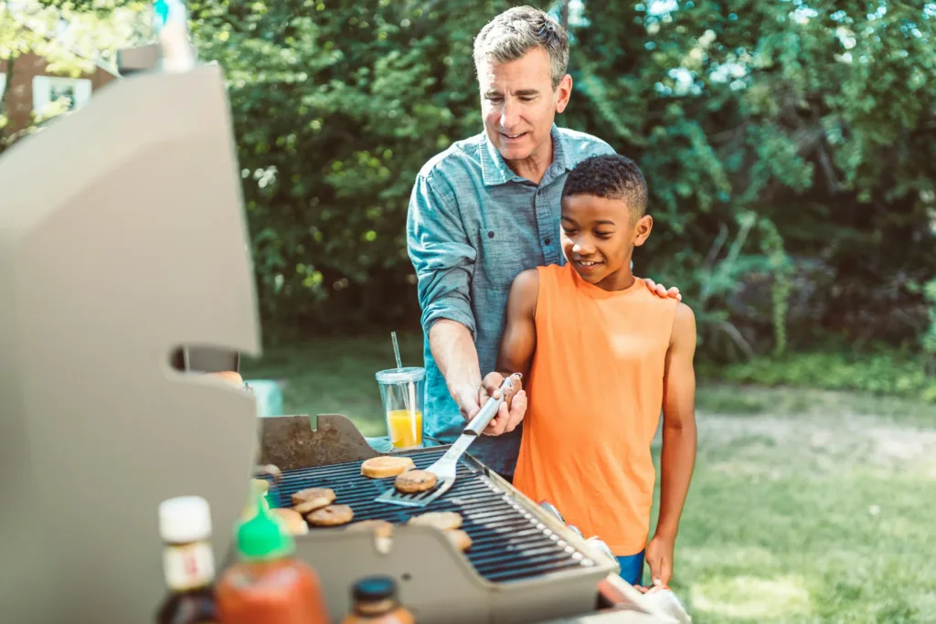 Man and boy near a bbq. Illustration for No Stress BBQ Organizing